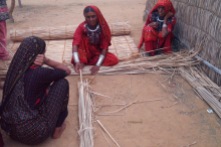The Jat women build their homes using grass and straw.